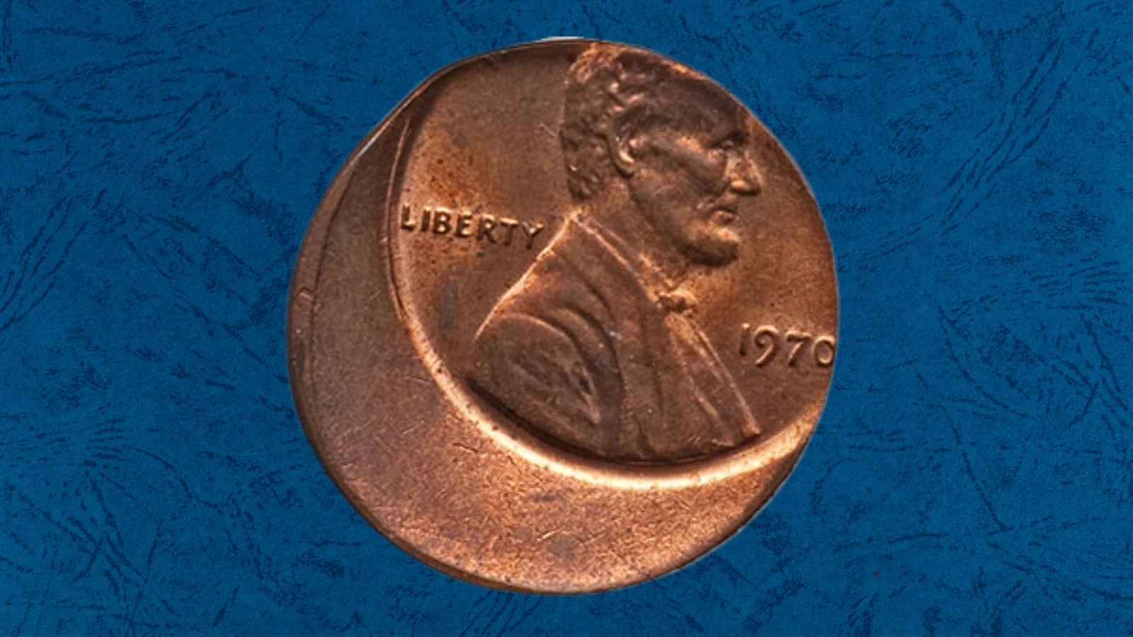 1970-D penny off-center strike error showing shifted design and blank planchet crescent